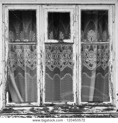 Closed old window with curtain