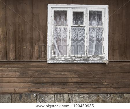 Closed old window with curtain.
