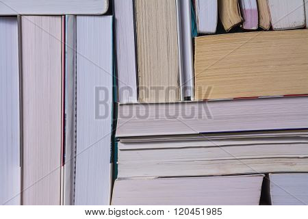 Stack of used old books on bookshelf