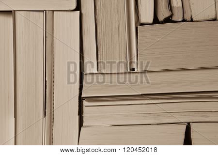 Stack of used old books on bookshelf
