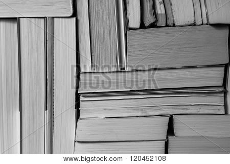 Stack of used old books on bookshelf