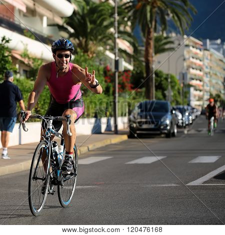 Cyclist Shows Devil Horns Gesture