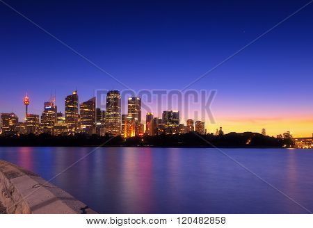 Australia Sydney city CBD view from cremorne point over harbour waters at sunset, taken by long expo