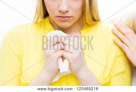 friendship, support, heartbreak and people concept - close up of crying teenage girl comforted by friend