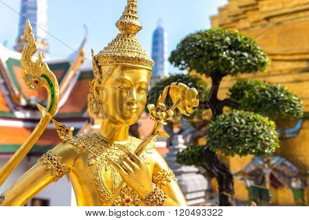 Golden Angel (Ki-nara) with Pagoda Wat Pra Kaeo, Grand Palace, Bangkok ,Thailand.