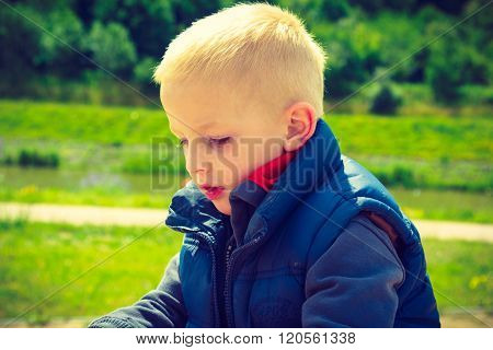 Pensive Boy Child Thinking And Daydreaming.