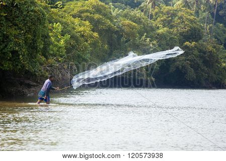 AGONDA, INDIA - OCTOBER 13, 2015: Unidnetified sea shore fisherman at Agonda beach India. Agonda is a traditional fishing village.