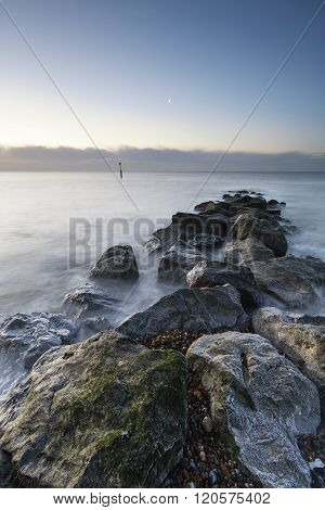 Stunning Sunrise Landscape Over Rocks In Sea