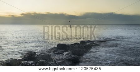 Stunning Sunrise Landscape Over Rocks In Sea
