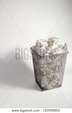 A Waste Paper Bin With Screwed Up Paper