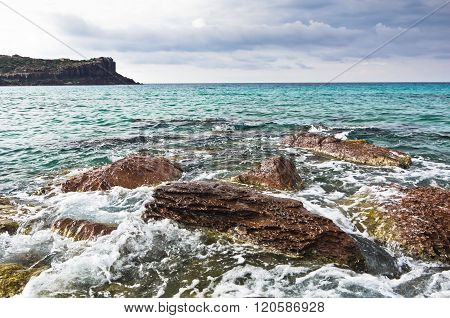 Sea rocks and waves at beach in San Pietro island, Sardinia