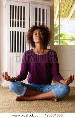 African American Woman Practising Yoga At Home