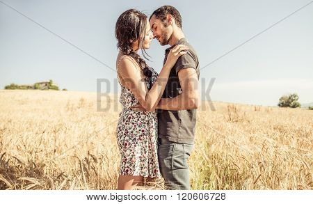Young Couple Kissing In A Wheat Field