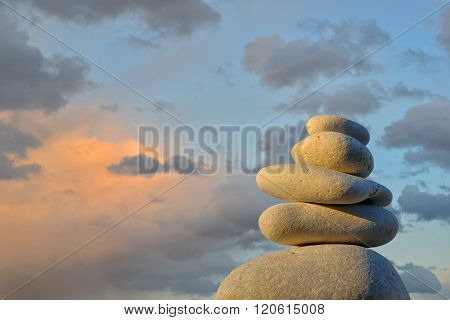 a stone pyramide in closeup before abendrot and clouds