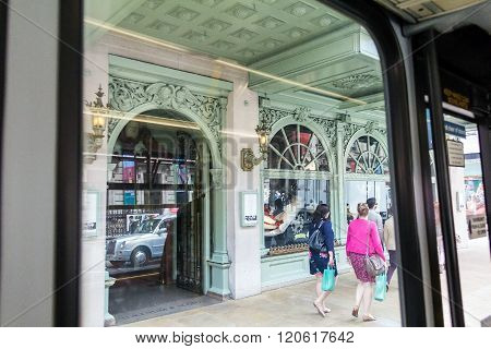 LONDON UK - JUNE 6 2015: Unidentified people in Piccadilly street . View from bus windiw. The city is visited by more than 30 million people every year.