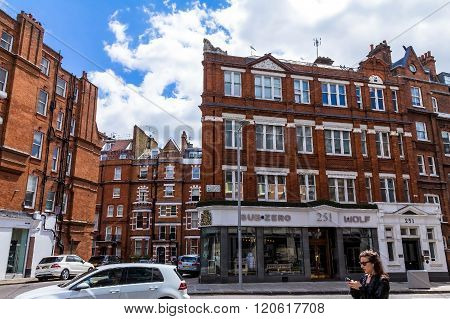 LONDON UK - JUNE 6 2015: Unidentified people and traffic on typical English Brompton road in a summer afternoon