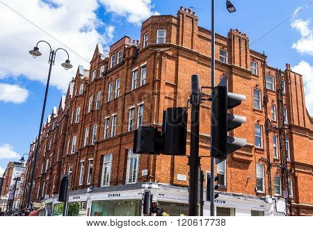 LONDON UK - JUNE 6 2015: Unidentified people and traffic on typical English Brompton road in a summer afternoon