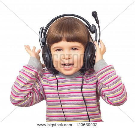 Beautiful little girl in headphones listening to music isolated on white background