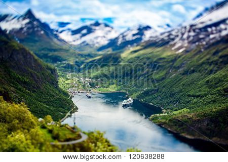 Geiranger fjord, Beautiful Nature Norway (tilt shift lens). It is a 15-kilometre (9.3 mi) long branch off of the Sunnylvsfjorden, which is a branch off of the Storfjorden (Great Fjord).