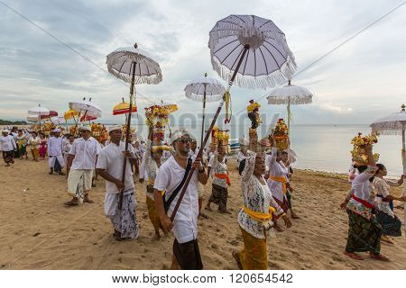 SANUR, BALI - MAR 18, 2016: Unidentified local people during ceremony Melasti Ritual. Melasti is a Hindu Balinese purification ceremony and one of the most important rituals of Bali island. 
