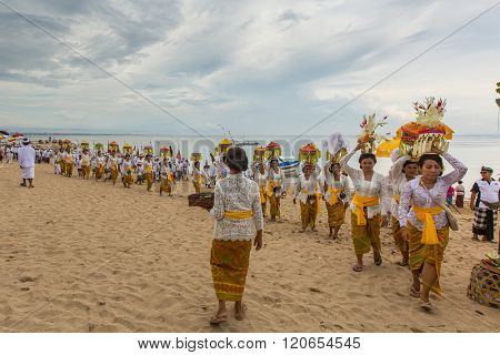 SANUR, BALI - MAR 18, 2016: Unidentified local people during ceremony Melasti Ritual. Melasti is a Hindu Balinese purification ceremony and one of the most important rituals of Bali island. 