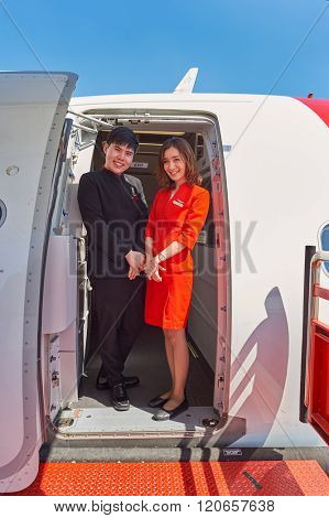 PATTAYA, THAILAND - FEBRUARY 26, 2016: crew members meet passengers of Thai AirAsia. Thai AirAsia is a joint venture of Malaysian low-fare airline AirAsia and Thailand's Asia Aviation