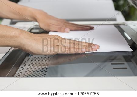 Woman Hands Putting A Sheet Of Paper Into A Copying Device