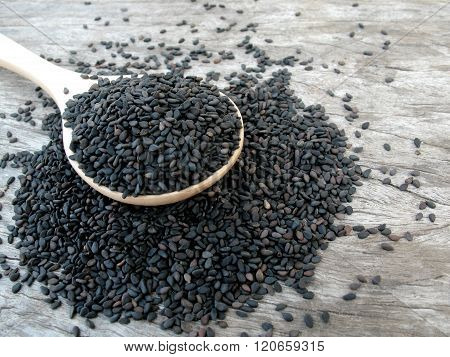 Black Sesame On Wooden Spoon And Old Wood  Background