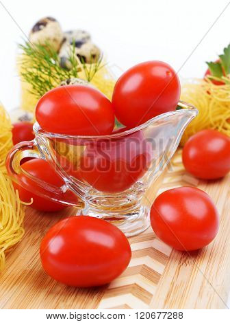 Glass Gravy Boat With Cherry Tomatoes.