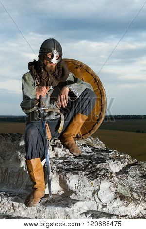 Knight Sitting On A Rock With A Sword