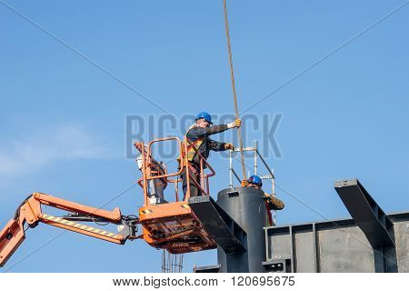 Belgrade Serbia - February 27 2016: Construction worker on a raised platform puts the reinforcement of the pillars of the building