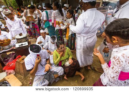 SANUR, BALI - MAR 18, 2016: Unidentified local people during performed Melasti Ritual. Melasti is a Hindu Balinese purification ceremony and ritual is held several days prior to the Nyepi holy day.
