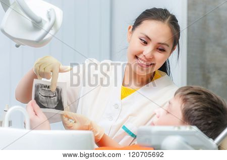 Dentist showing x-ray to a patient