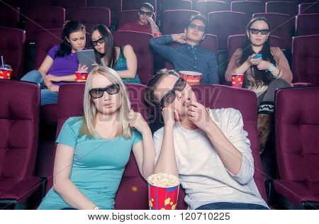 People in the cinema wearing 3d glasses