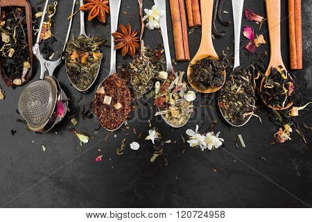 Tea In Spoon On Rustic Black Background.