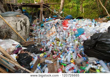 KO MOOK ISLAND, THAILAND, JANUARY 07, 2016 : Heap of soda and water plastic bottle, stored before burning or recycling, Ko Mook island, Thailand