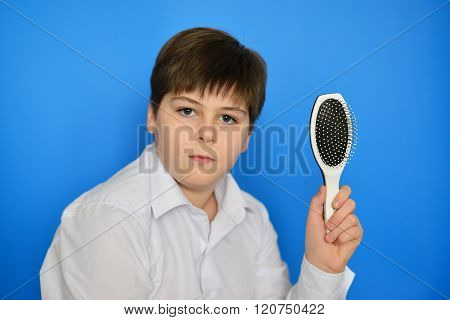 Boy teenager with a comb in his hand
