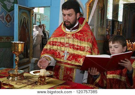 LUTSK UKRAINE - NOVEMBER 02 - Orthodox priest and little sextons during holiday prayers in Lutsk on November 02 2008.