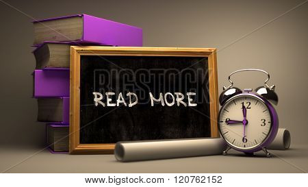 Hand Drawn Read More Concept on Chalkboard.