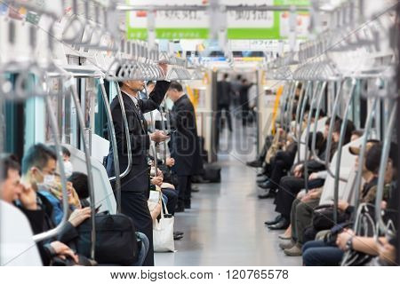 Passengers traveling by Tokyo metro.