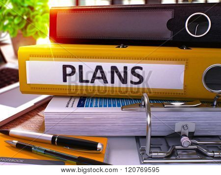Plans on Yellow Office Folder. Toned Image.