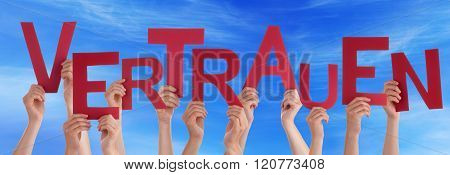 People Holding German Word Vertrauen Means Trust Blue Sky