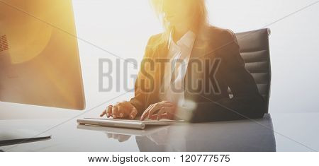 Photo of businesswoman working at table in modern, empty office. White background, wide