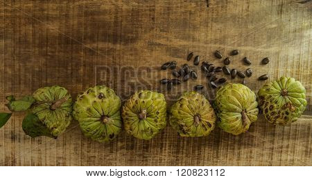 Ripe Sugar-apple Seeds By Unbroken Fruits On Wooden Table
