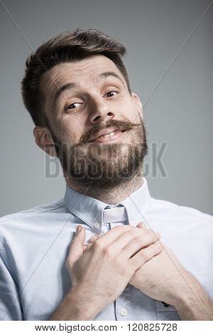 Man is looking imploring over gray background
