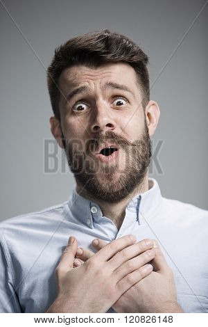 Man is looking imploring over gray background