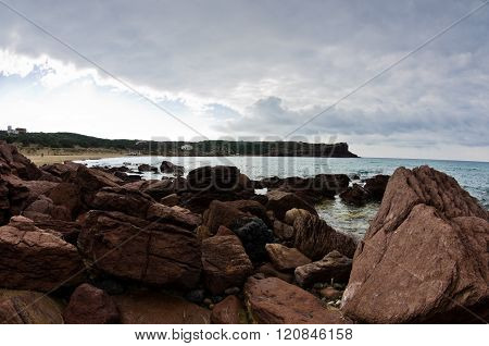 Sea rocks and waves at beach in San Pietro island, Sardinia