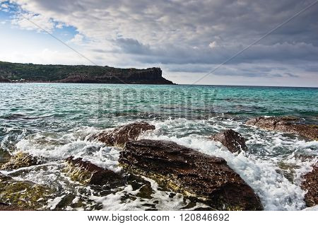 Sea rocks and waves at beach in San Pietro island, Sardinia