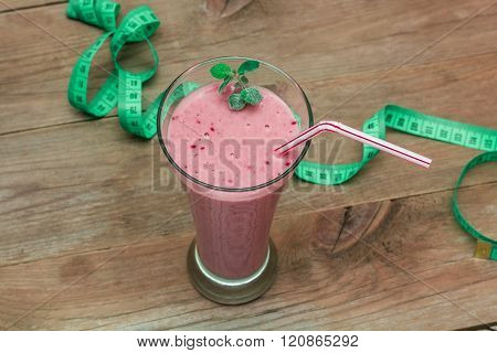 Glass Of Fruit Smoothie And A Measuring Tape