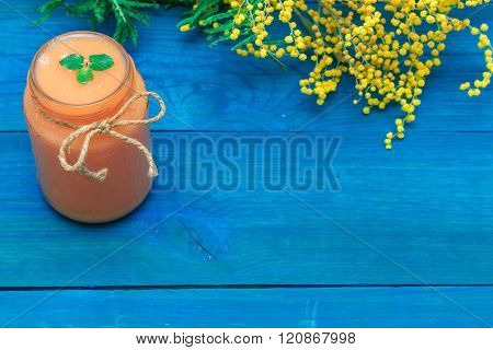 Glass Of Fruit Smoothies, And Nearby Are The Flowers Of Mimosa